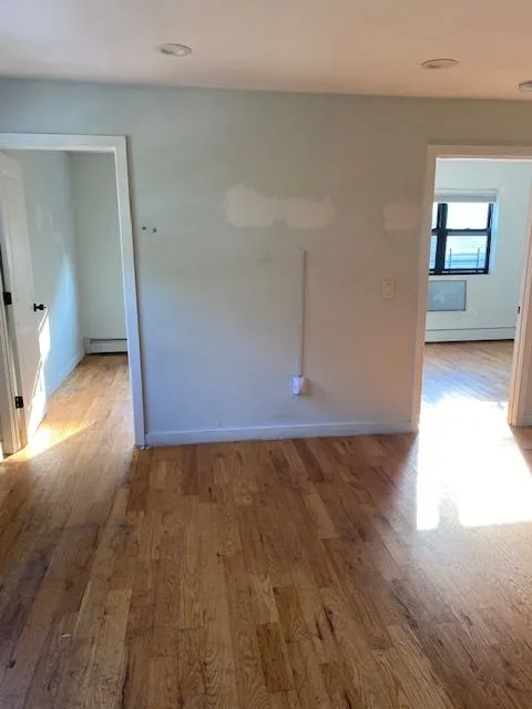 Caesar Pl 2L living area with hardwood floors and doorways leading to adjoining rooms