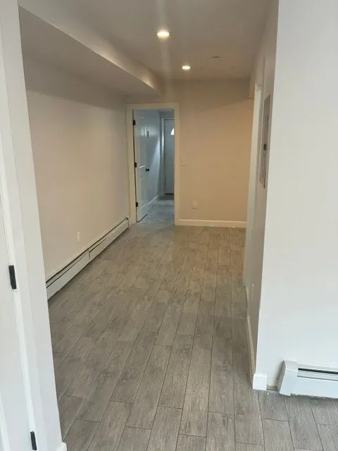 Yonkers Ave #1 interior hallway with gray tile flooring, white walls, and recessed lights